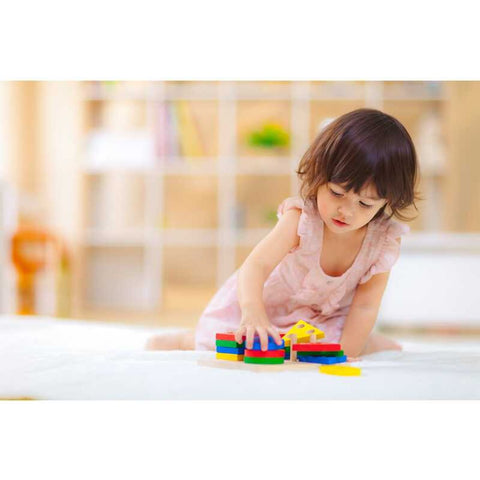 Kid playing PlanToys Geometric Sorting Board