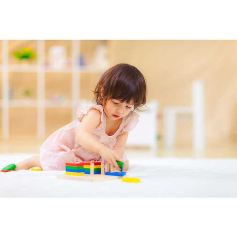 Kid playing PlanToys Geometric Sorting Board