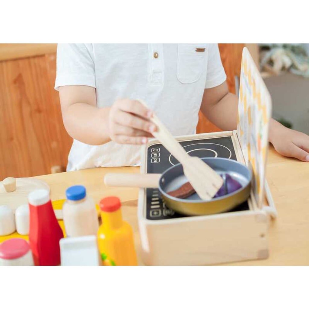 Kid playing PlanToys Cooking Utensils Set