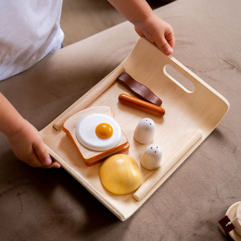 Kid playing PlanToys Breakfast Menu