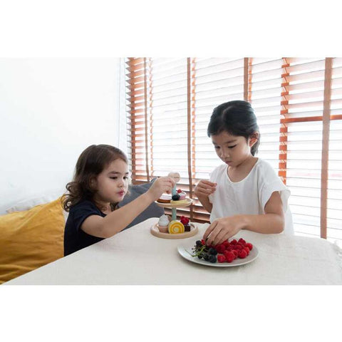 Kid playing PlanToys Bakery Stand Set