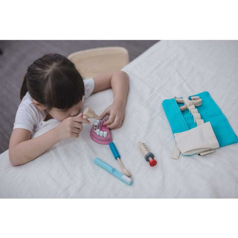 Kid playing PlanToys Dentist Set