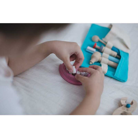 Kid playing PlanToys Dentist Set