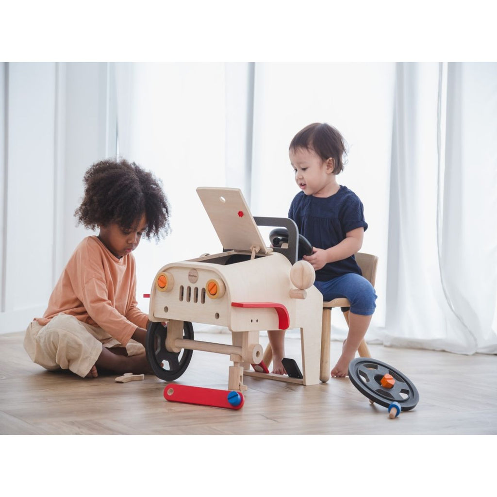 Kid playing PlanToys Motor Mechanic