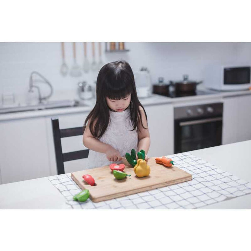 Kid playing PlanToys Wonky Fruit & Vegetables