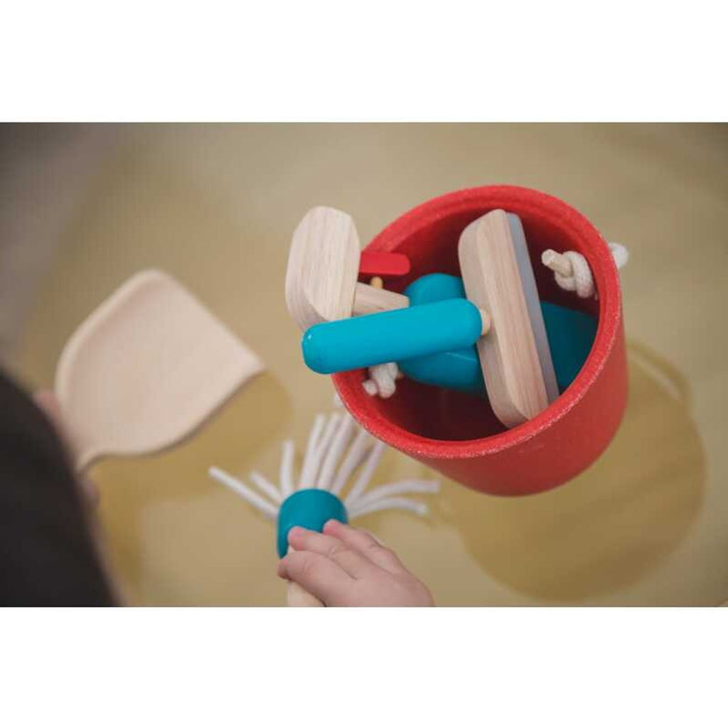 Kid playing PlanToys Cleaning Set