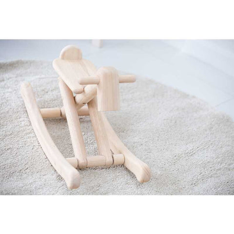 Kid playing PlanToys Foldable Rocking Horse