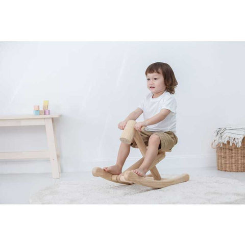 Kid playing PlanToys Foldable Rocking Horse