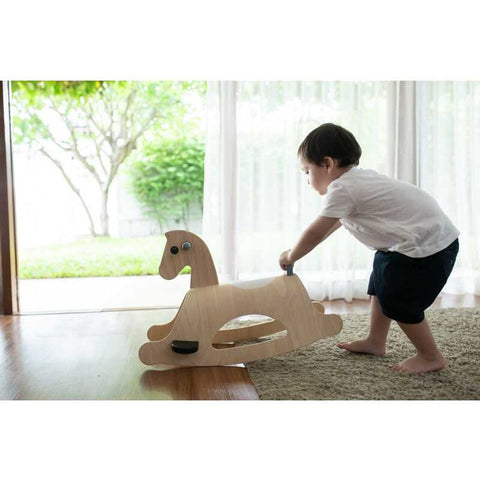 Kid playing PlanToys Palomino Mono