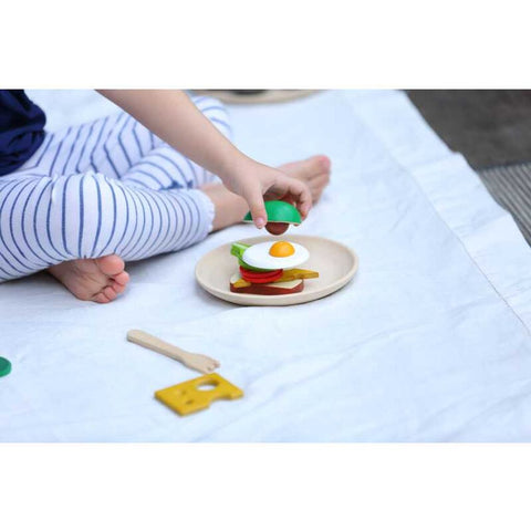 Kid playing PlanToys Breakfast Set