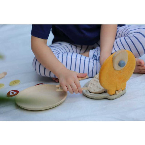 Kid playing PlanToys Waffle Set