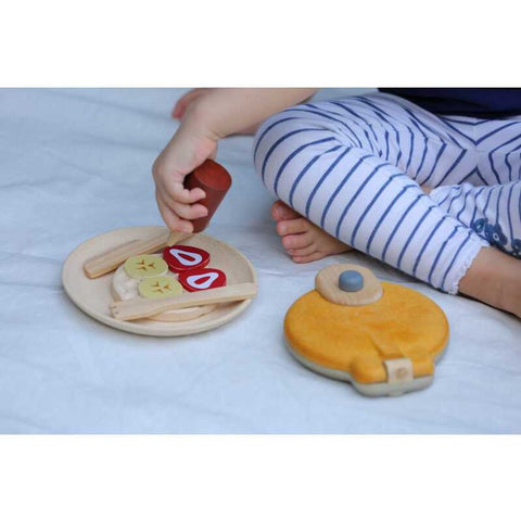 Kid playing PlanToys Waffle Set