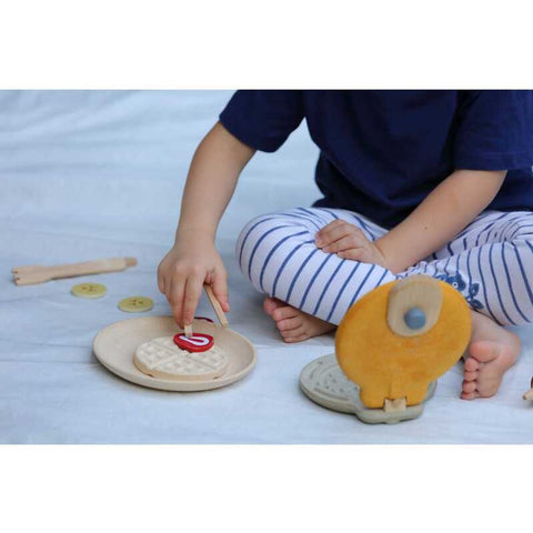 Kid playing PlanToys Waffle Set