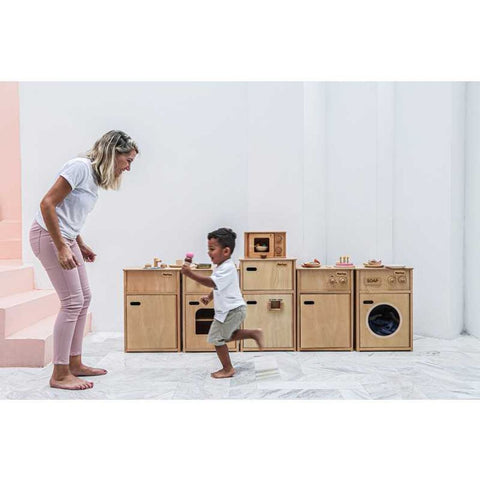 Kid playing PlanToys Microwave