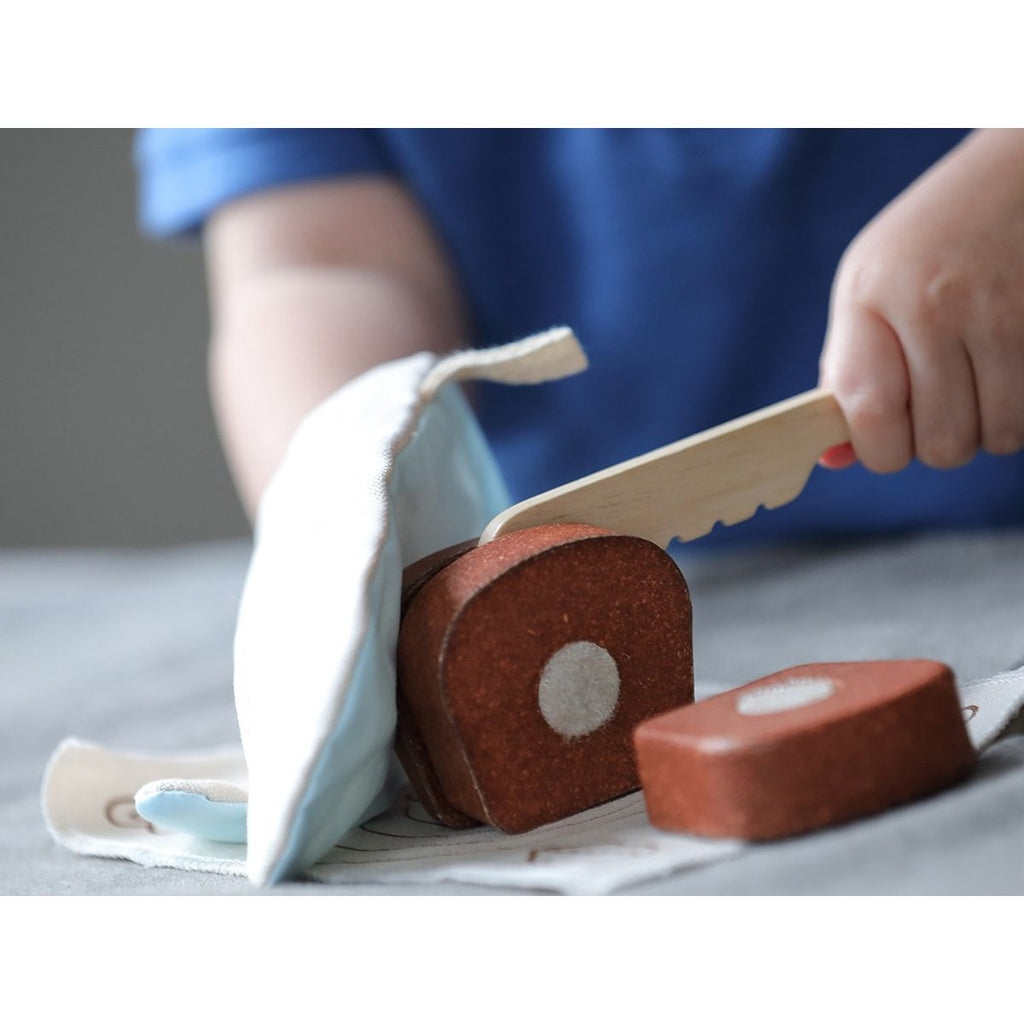 Kid playing PlanToys Bread Loaf Set