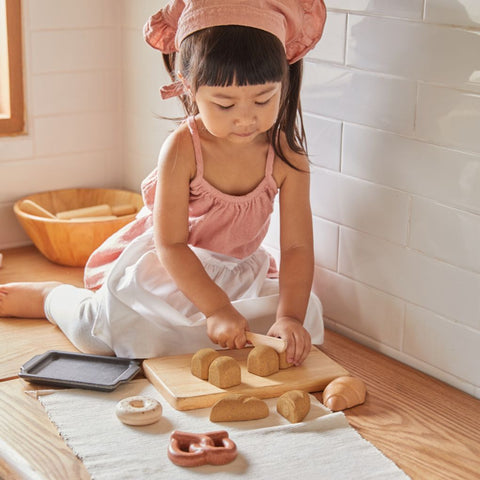 Kid playing PlanToys Bread Set