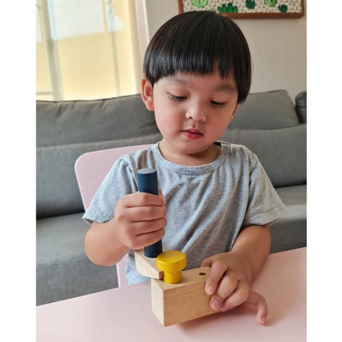 Kid playing PlanToys Handy Carpenter Set