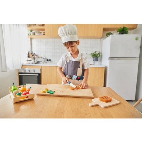 Kid playing PlanToys Chef Set