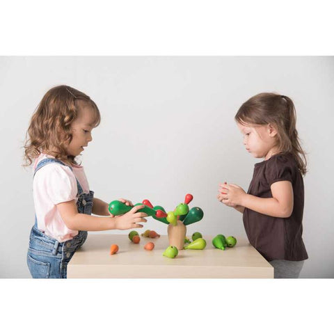 Kid playing PlanToys Balancing Cactus