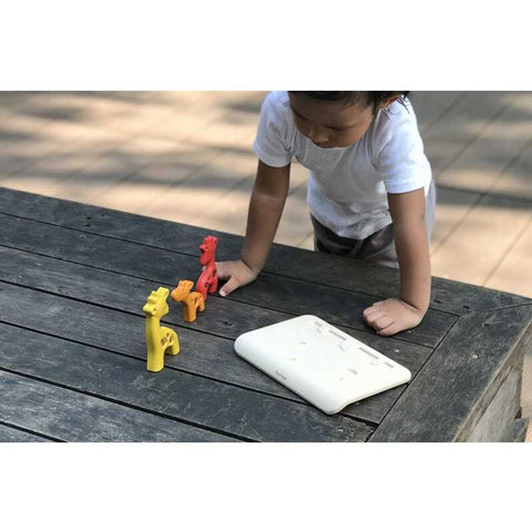 Kid playing PlanToys Giraffe Puzzle