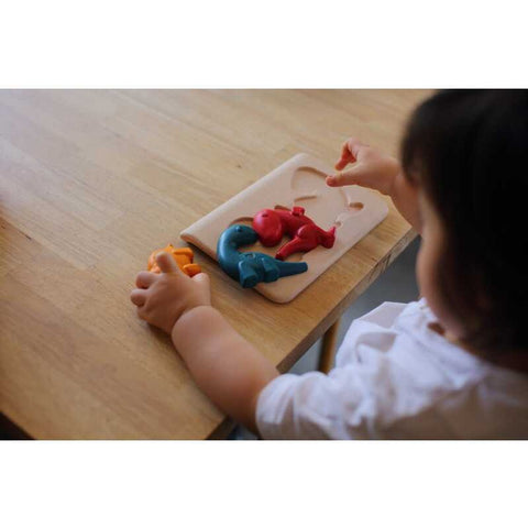 Kid playing PlanToys Dino Puzzle