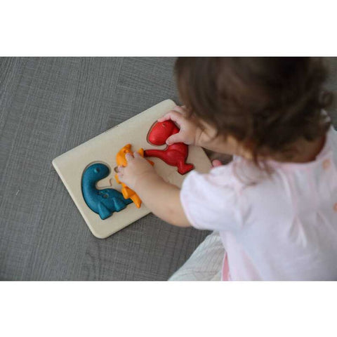 Kid playing PlanToys Dino Puzzle