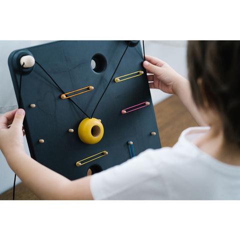 Kid playing PlanToys Wall Ball Game