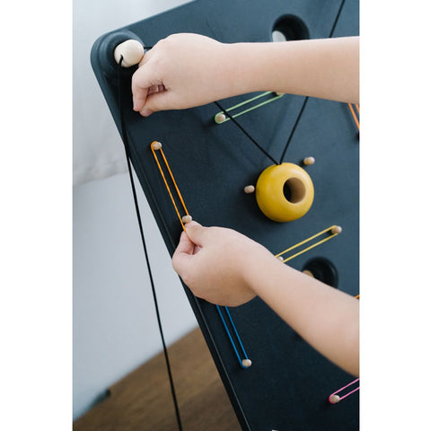 Kid playing PlanToys Wall Ball Game