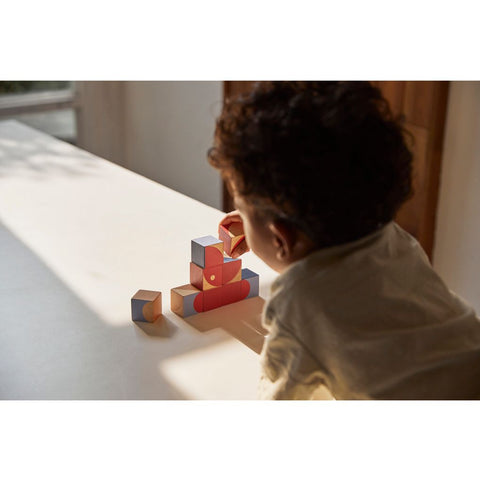 Kid playing PlanToys Geo Pattern Cubes