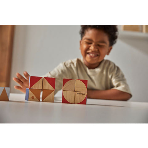 Kid playing PlanToys Geo Pattern Cubes