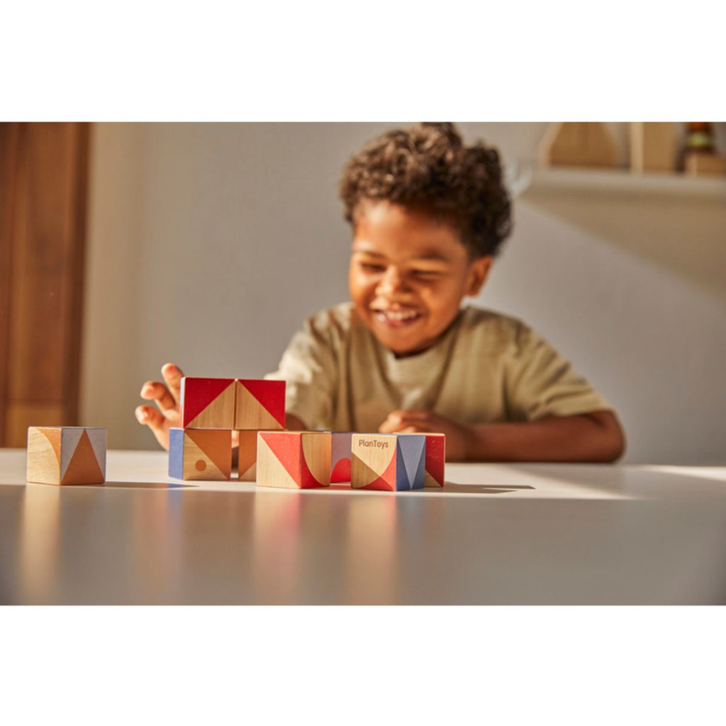 Kid playing PlanToys Geo Pattern Cubes