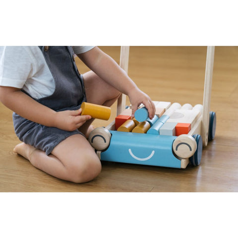 Kid playing PlanToys Baby Walker - Orchard