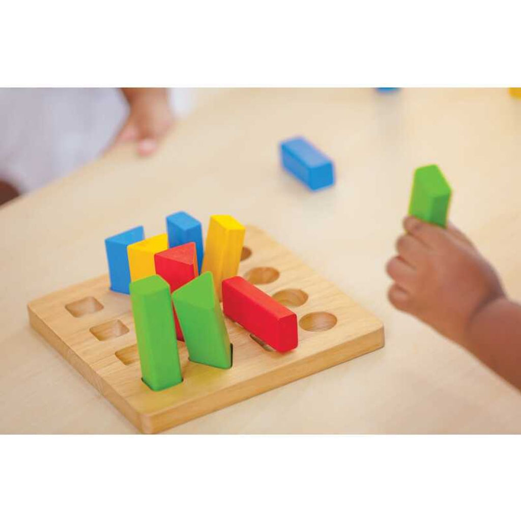 Kid playing PlanToys Geometric Peg Board