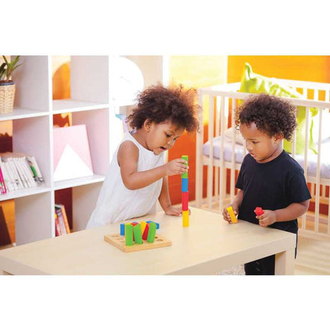 Kid playing PlanToys Geometric Peg Board