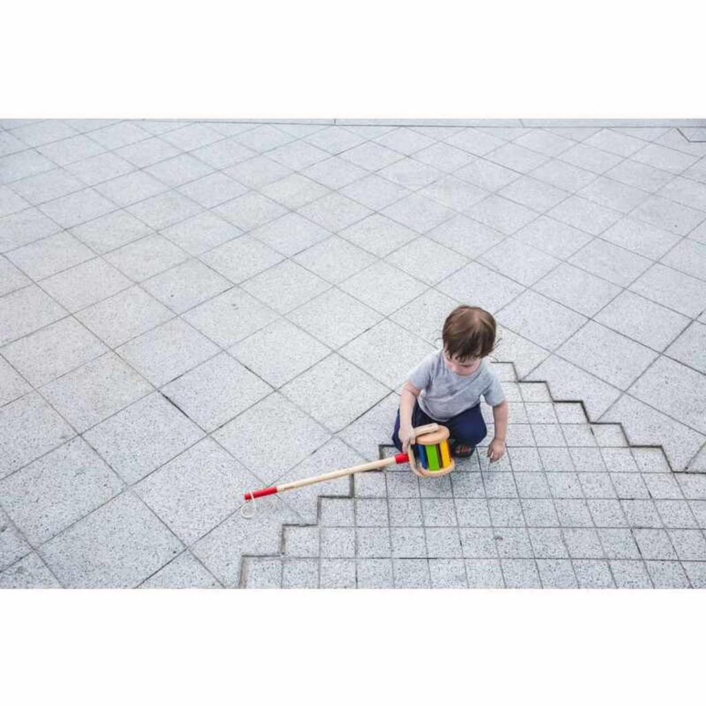 Kid playing PlanToys Walk N Roll