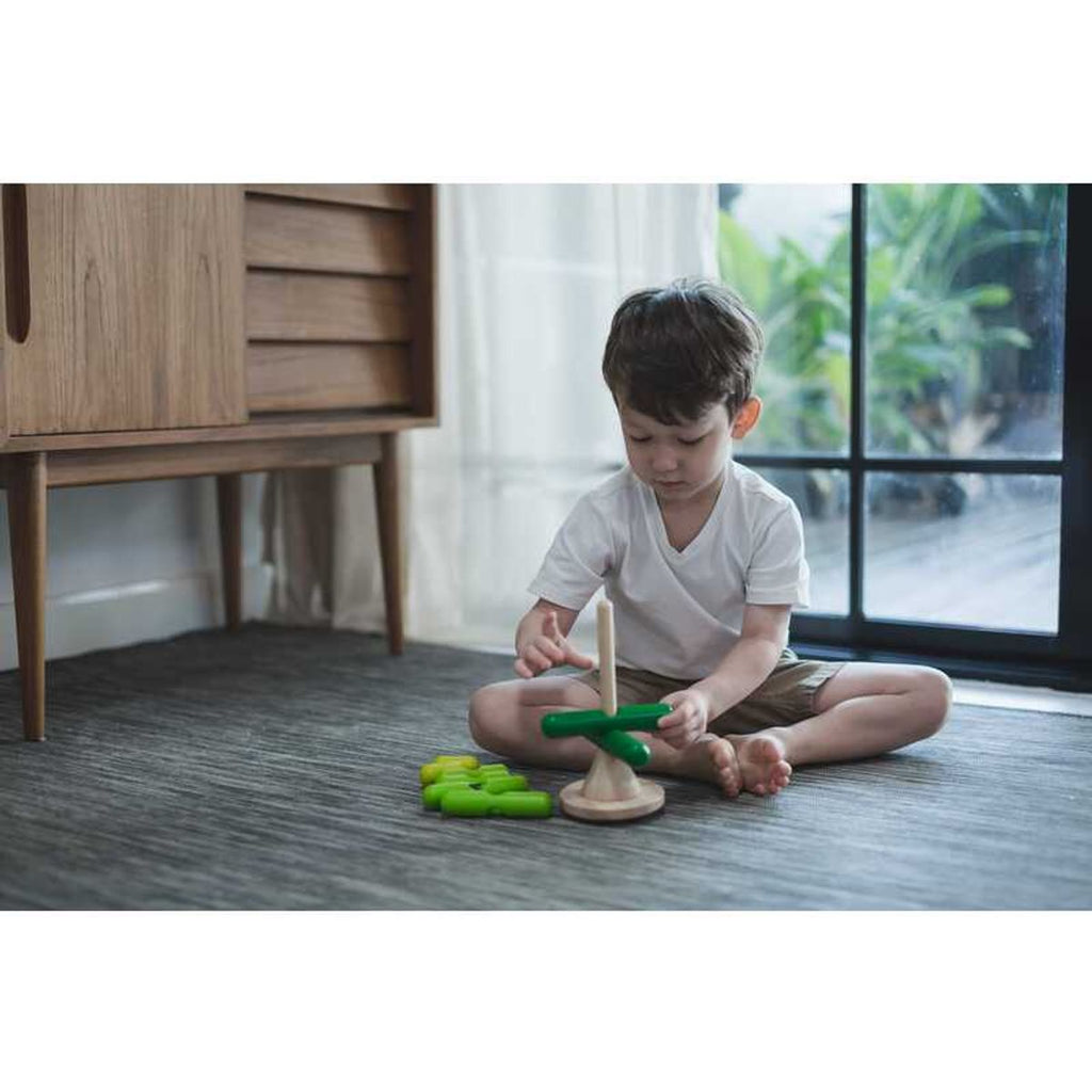 Kid playing PlanToys Stacking Tree