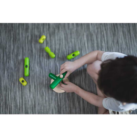 Kid playing PlanToys Stacking Tree