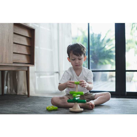 Kid playing PlanToys Stacking Tree