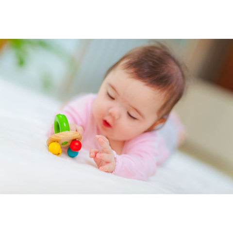 Kid playing PlanToys Bell Rattle