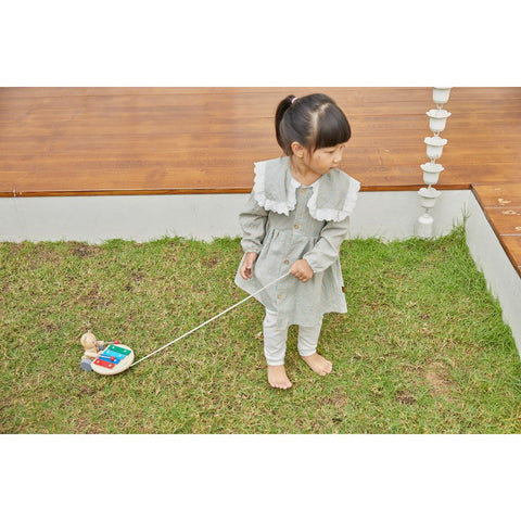 Kid playing PlanToys Pull Along Musical Bear