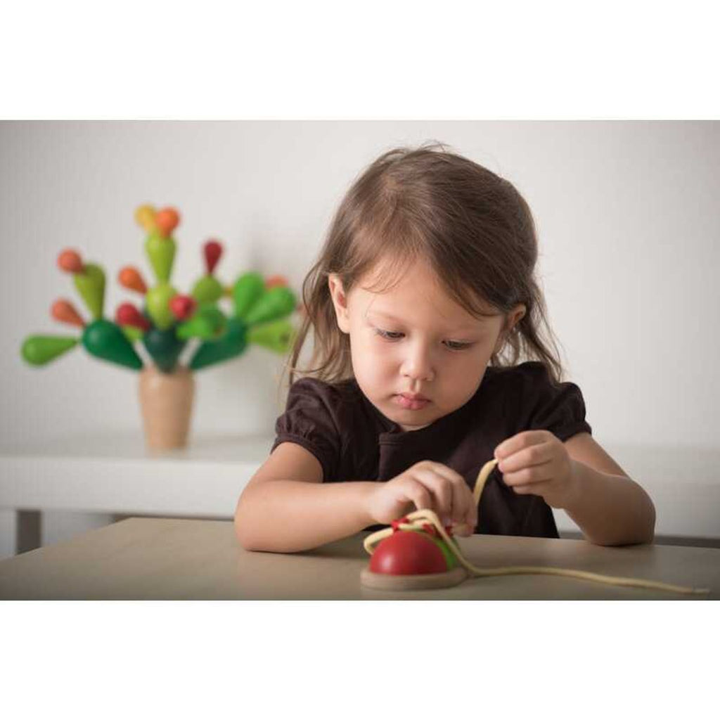 Kid playing PlanToys Tie Up Shoe