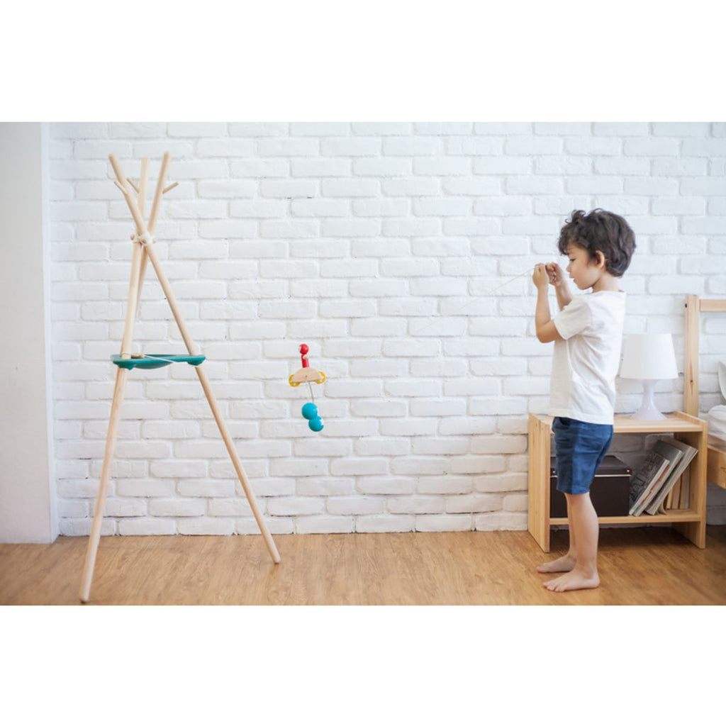 Kid playing PlanToys Riding Acrobat