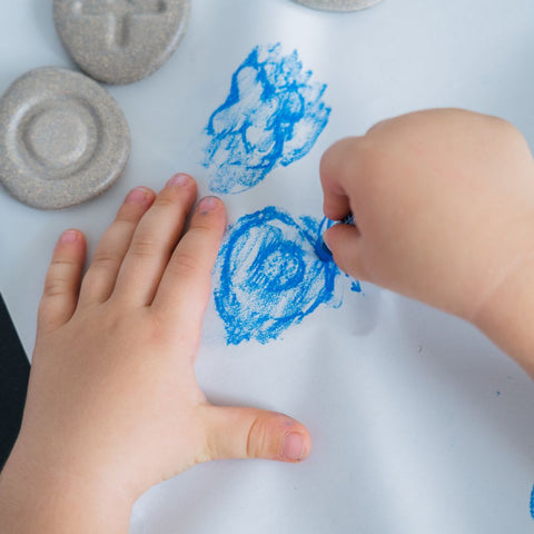 Kid playing PlanToys Tactile Stone