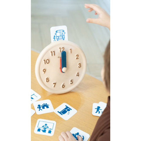 Kid playing PlanToys Activity Clock