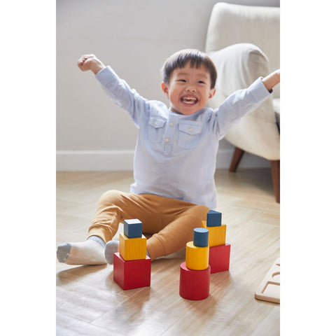 Kid playing PlanToys Nesting Puzzle - Unit Plus