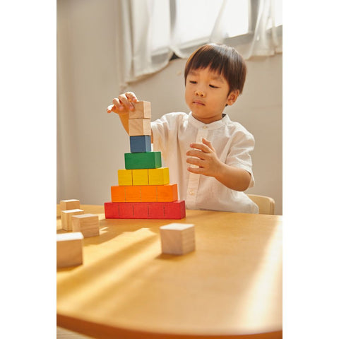 Kid playing PlanToys Colored Counting Blocks - Unit Plus