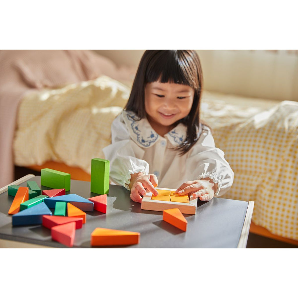 Kid playing PlanToys Fraction Blocks - Unit Plus