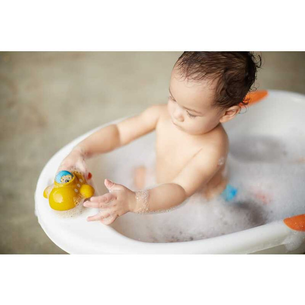 Kid playing PlanToys Submarine