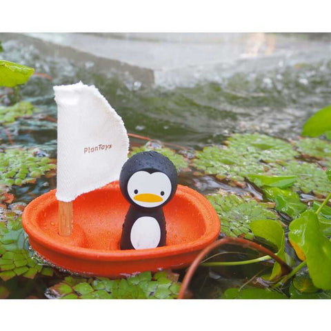 Kid playing PlanToys Sailing Boat - Penguin