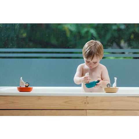 Kid playing PlanToys Sailing Boat - Polar Bear